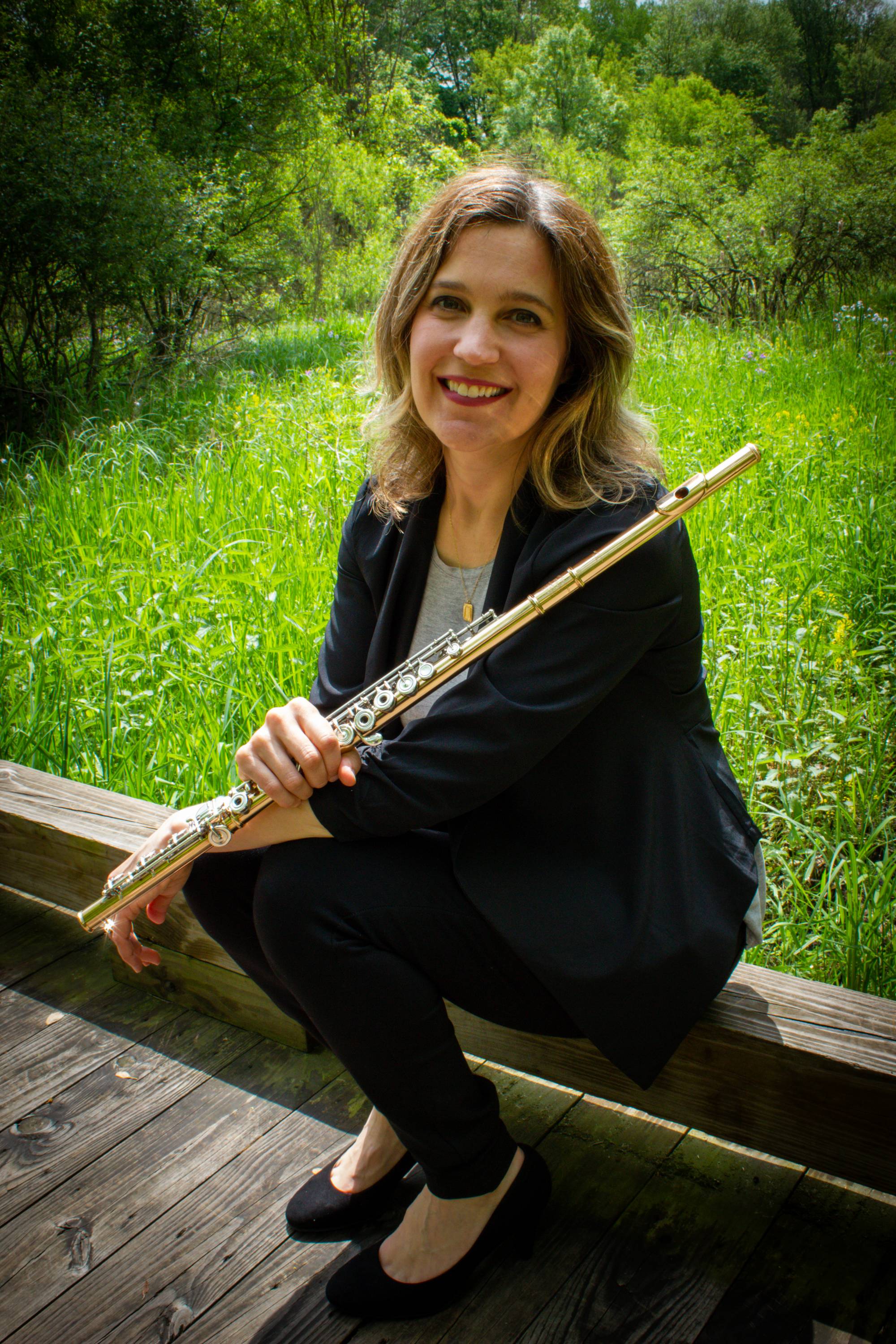 photo of professor Abigail Walsh holding flute